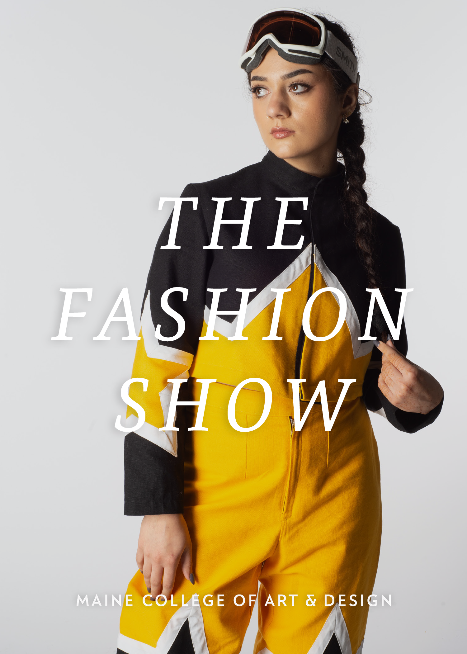 White text reading "The Fashion Show" is over a photo of a model wearing an athletic ski-inspired outfil with a yellow and black cropped jacket with stars on the elbows and high waisted yellow and black pants.