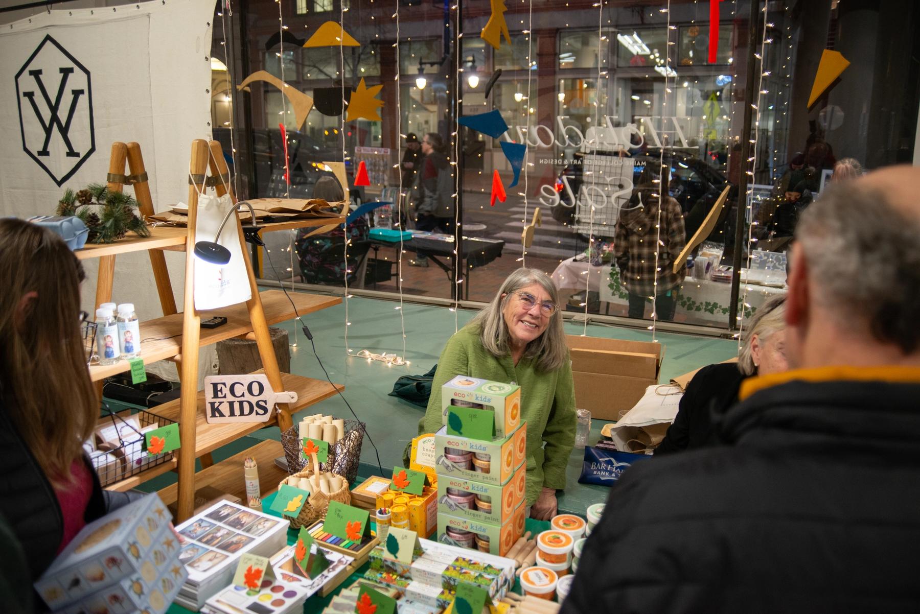 Vendor speaking with shoppers at the Holiday Sale. Photo by Annabelle Collette '22.