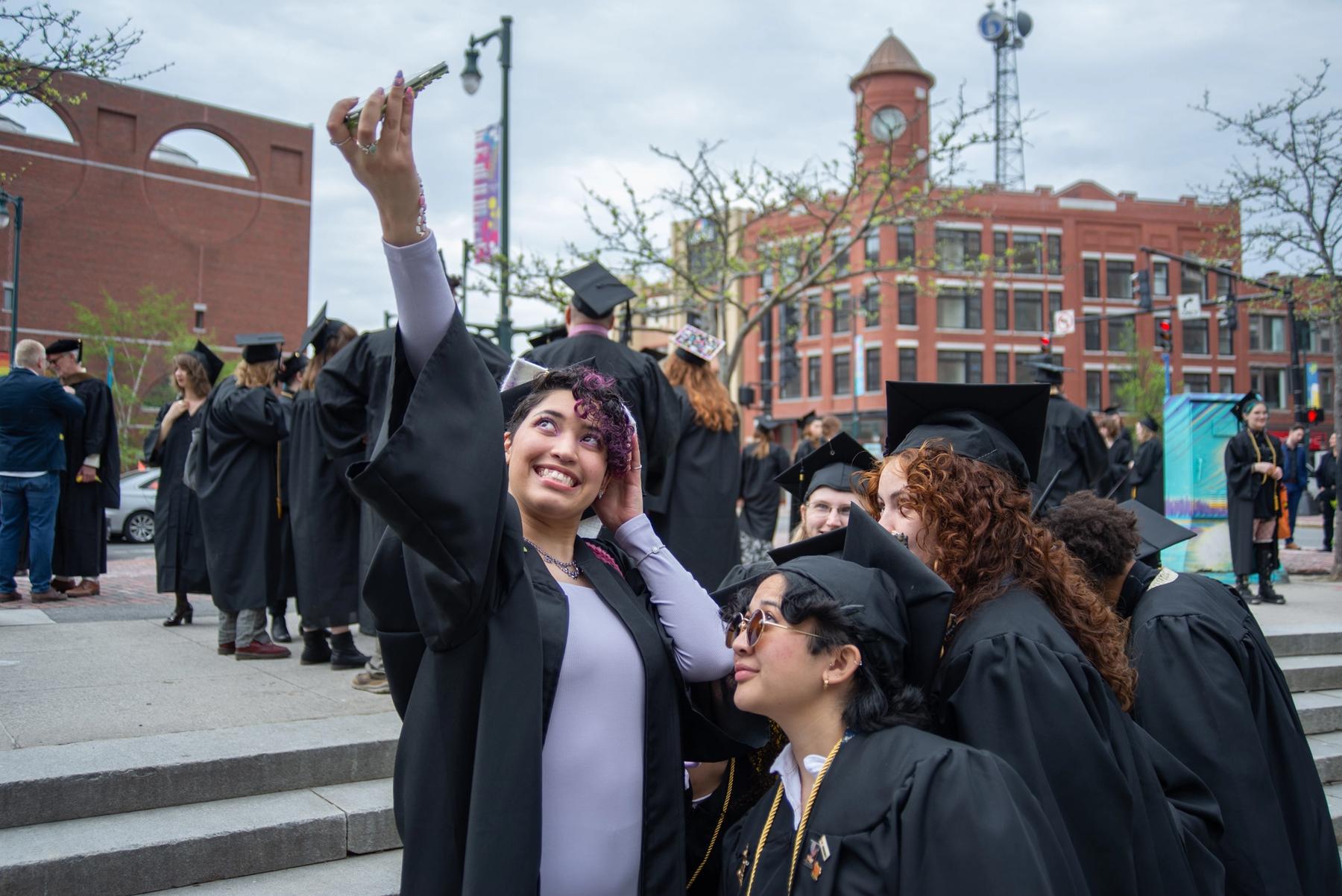 Three graduating students taking a selfie.