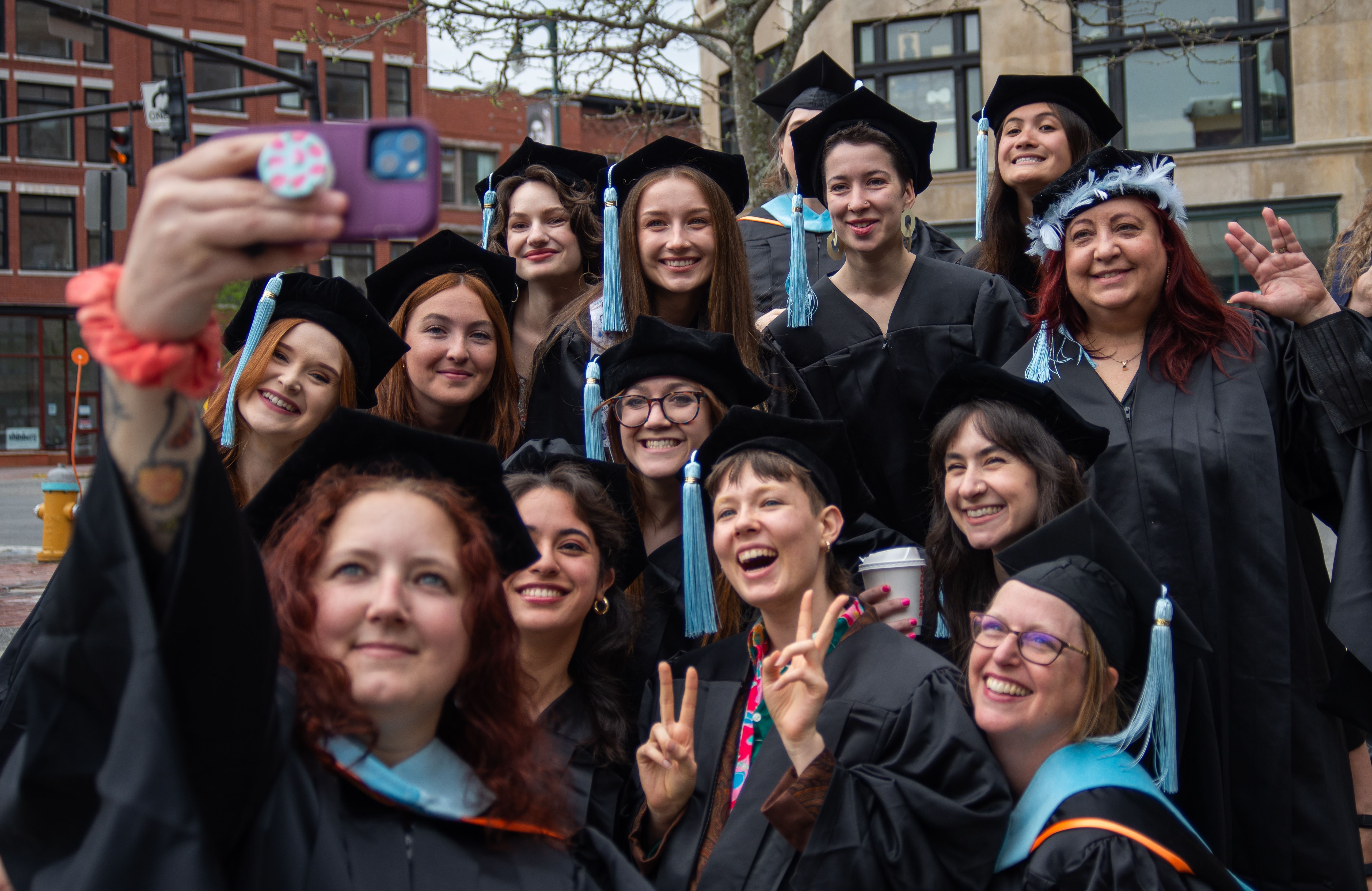 A group of graduating students taking a selfie.