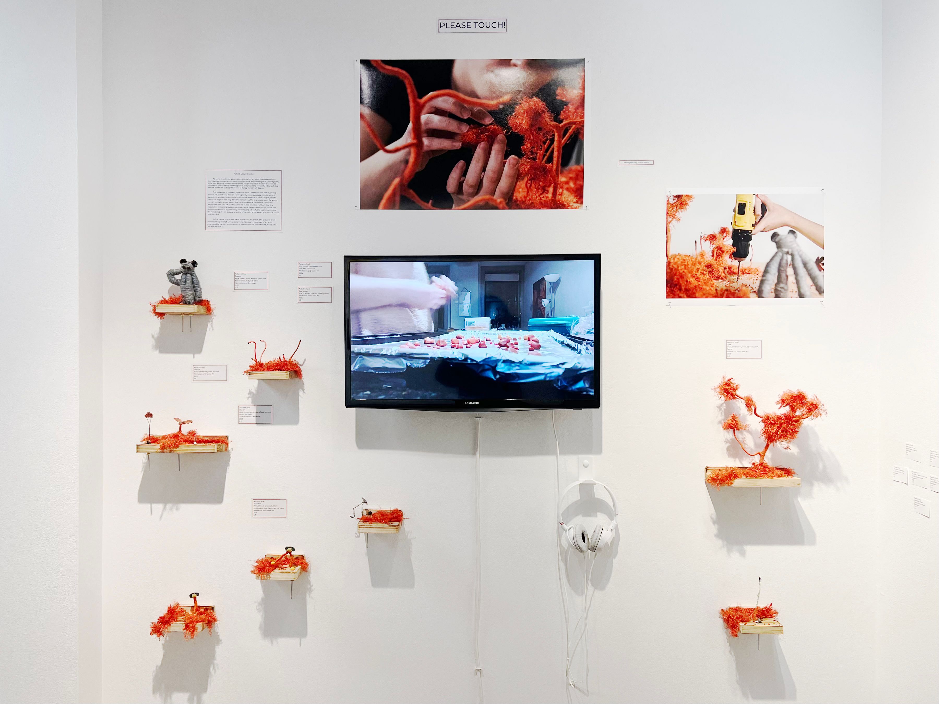 An installation of a stop-motion animation with orange models.