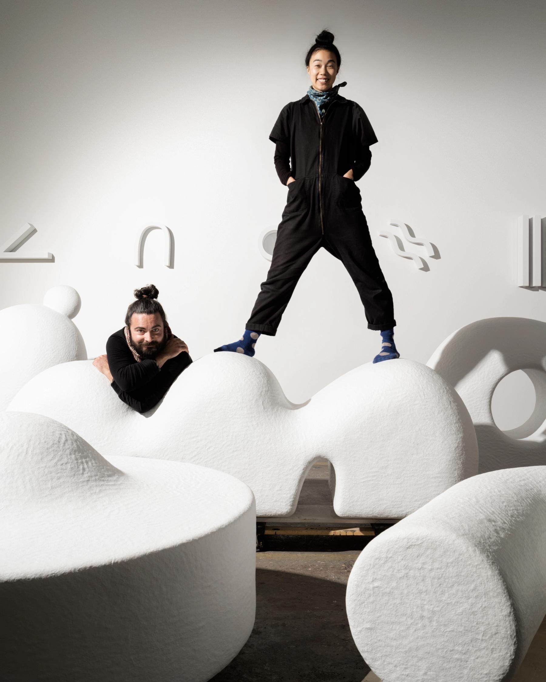 Adam Frezza & Terri Chiao posing with their sculptures.