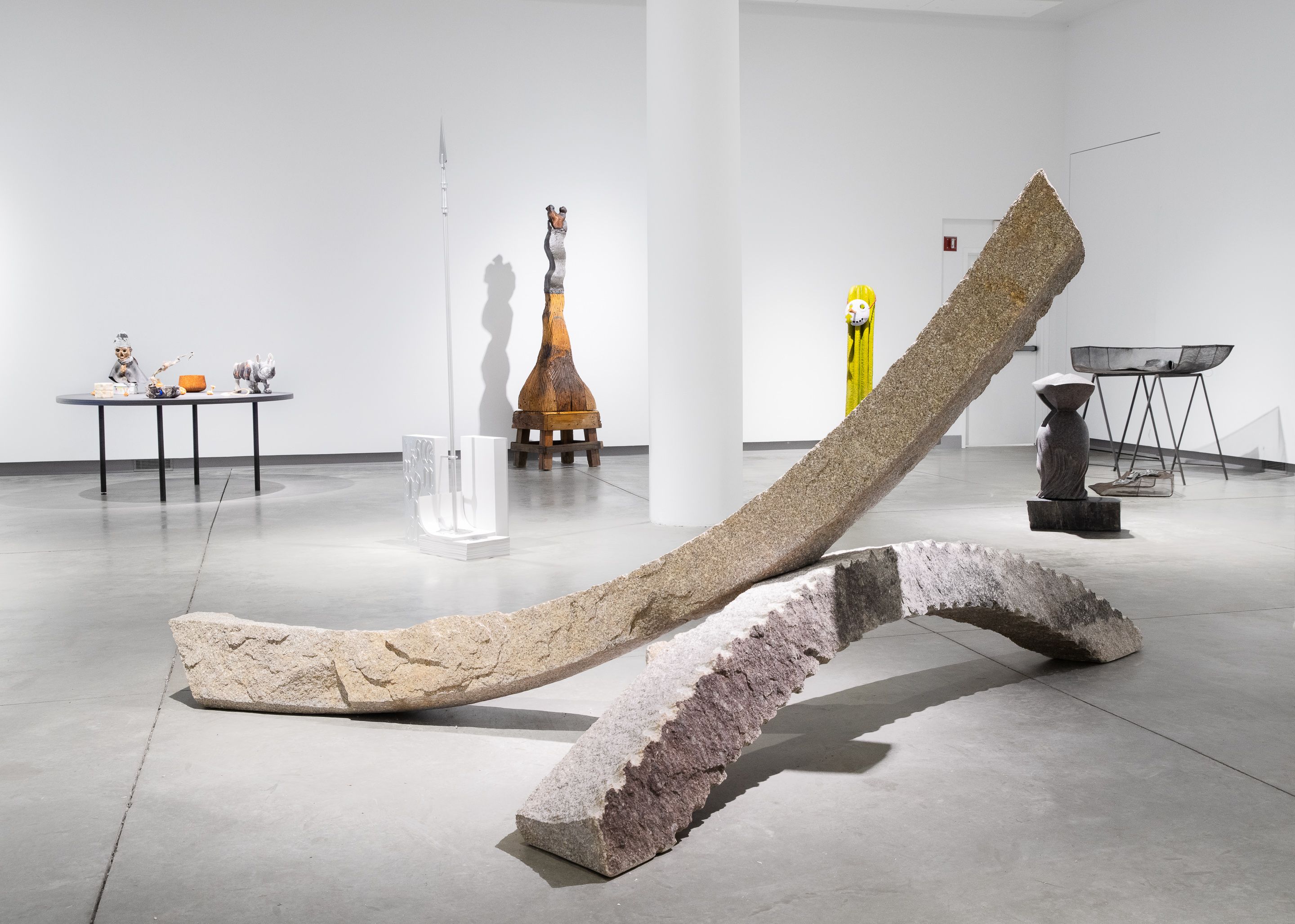 Installation view of a sculpture made from two stone arcs.