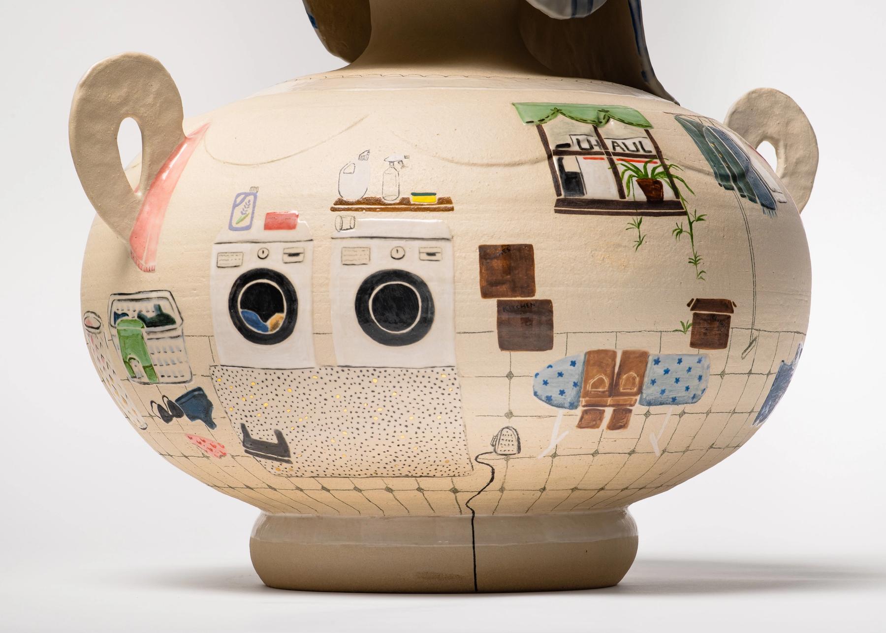 A greek-inspired ceramic vase with a scene of a laundry room.