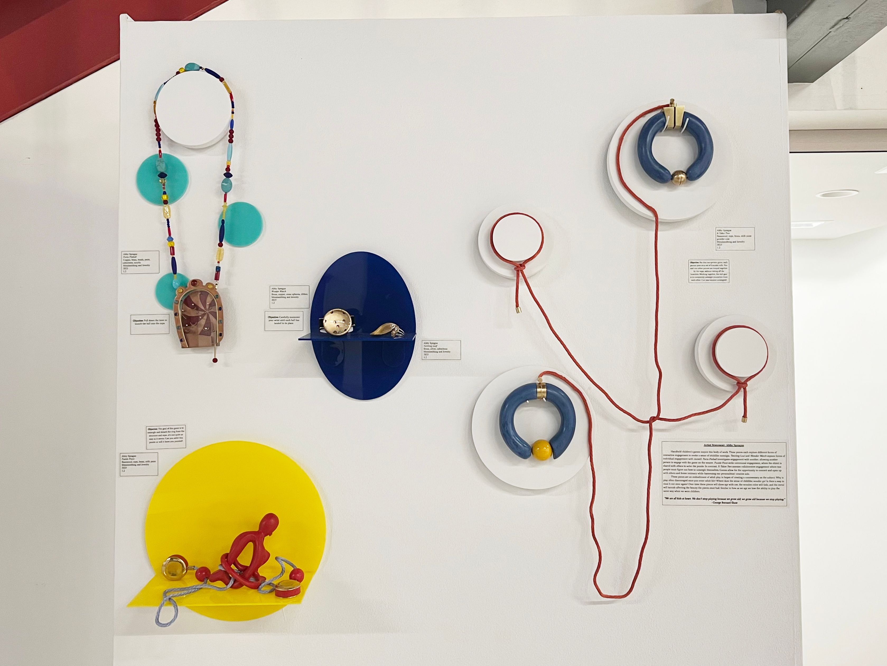 Installation of jewelry with bright colors and circular shapes.