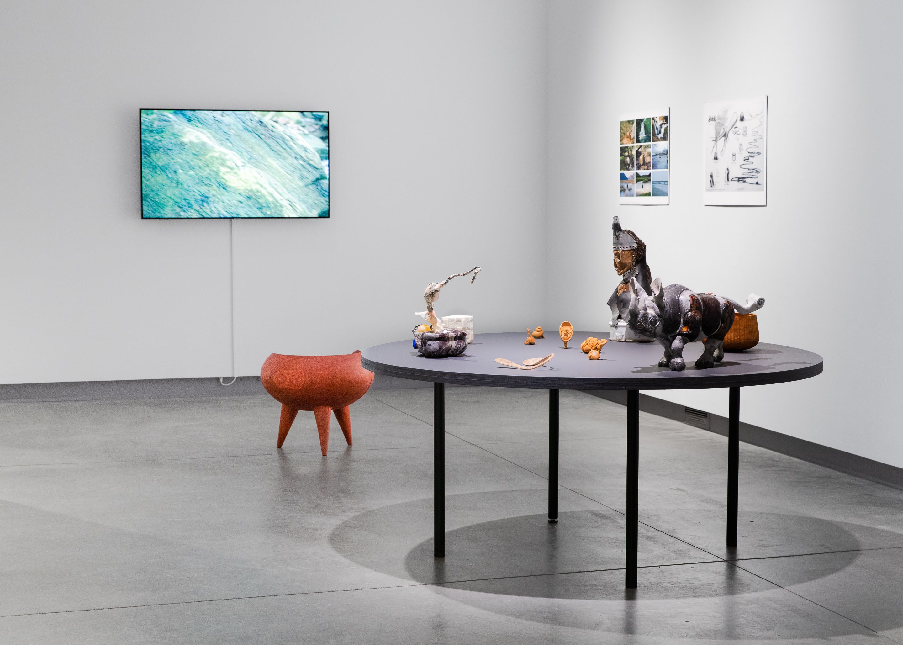 Installation view of several small sculptures on a table.