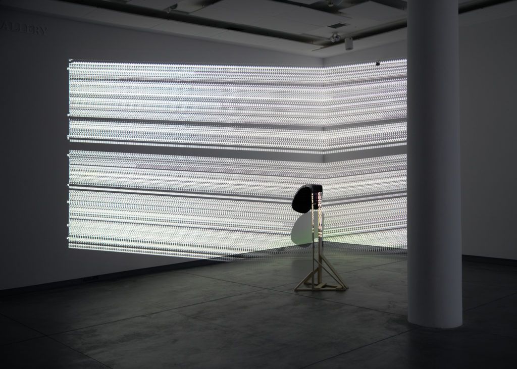 Installation view of a patterned projection on a sculpture.