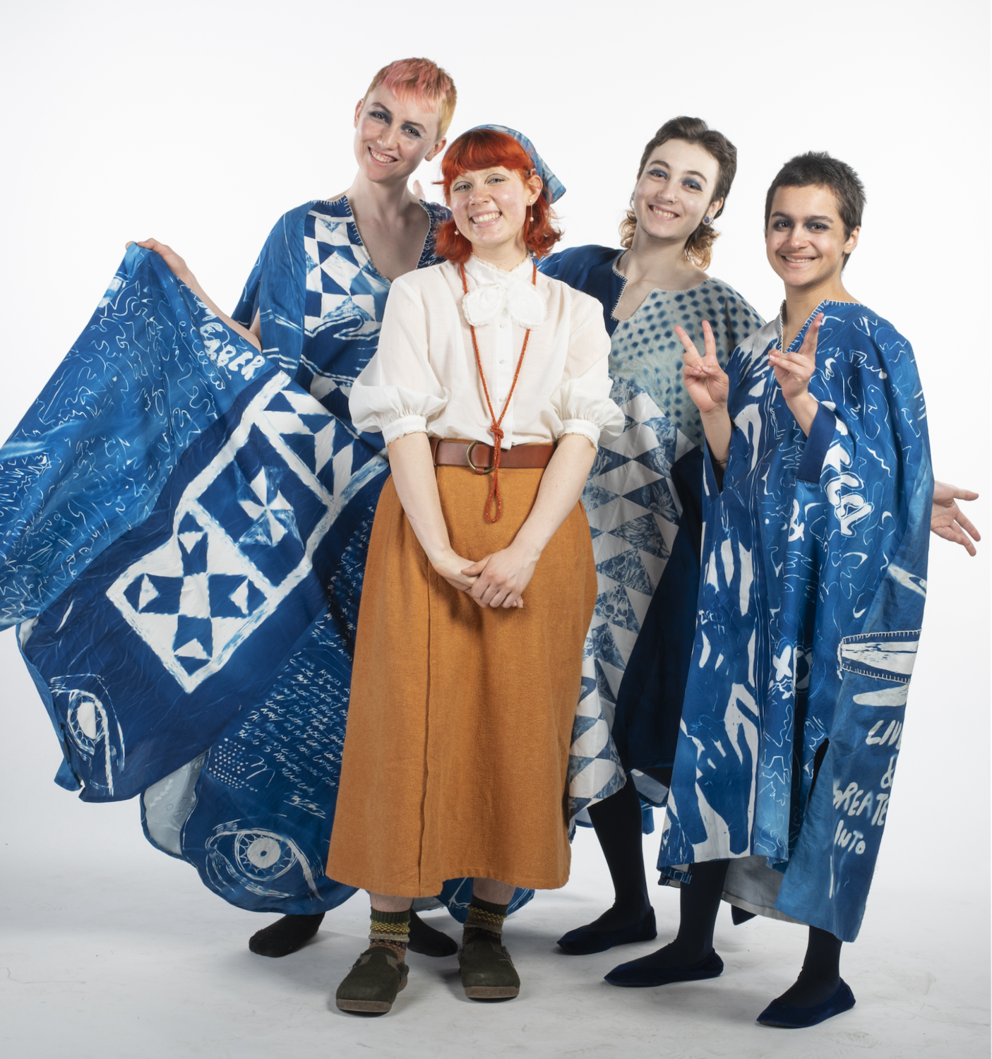 Dan Toomre standing in front of models wearing cyanotype garments.