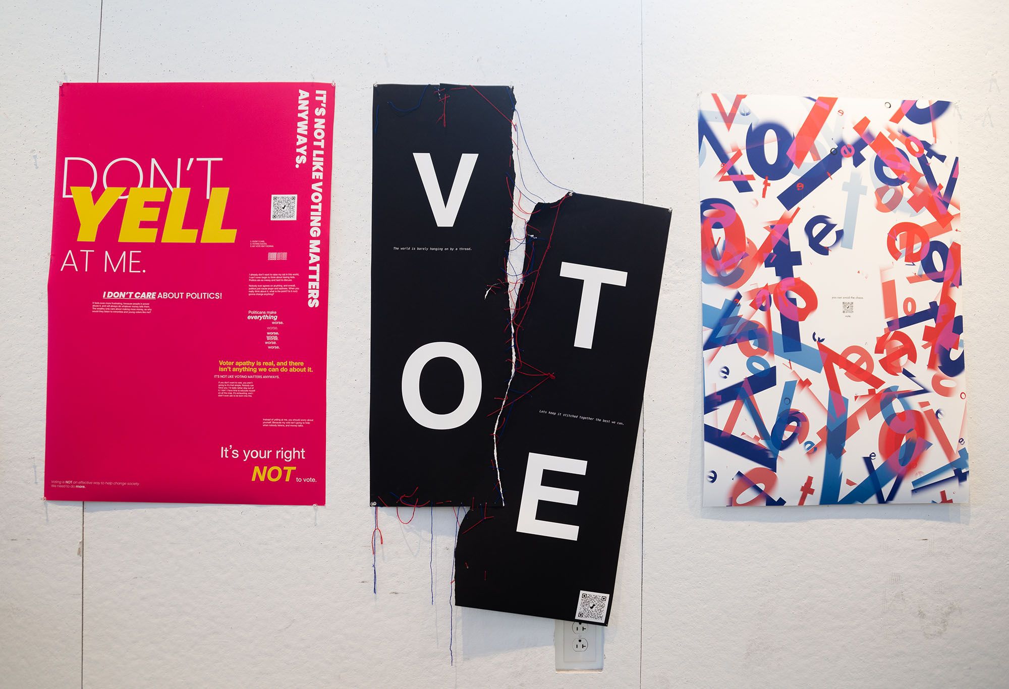 Three vote posters. The left is pink and yellow with the text "Don't yell at me"; the middle is black and torn in half, connected by red string; and the right is a jumple of red and blue letters.