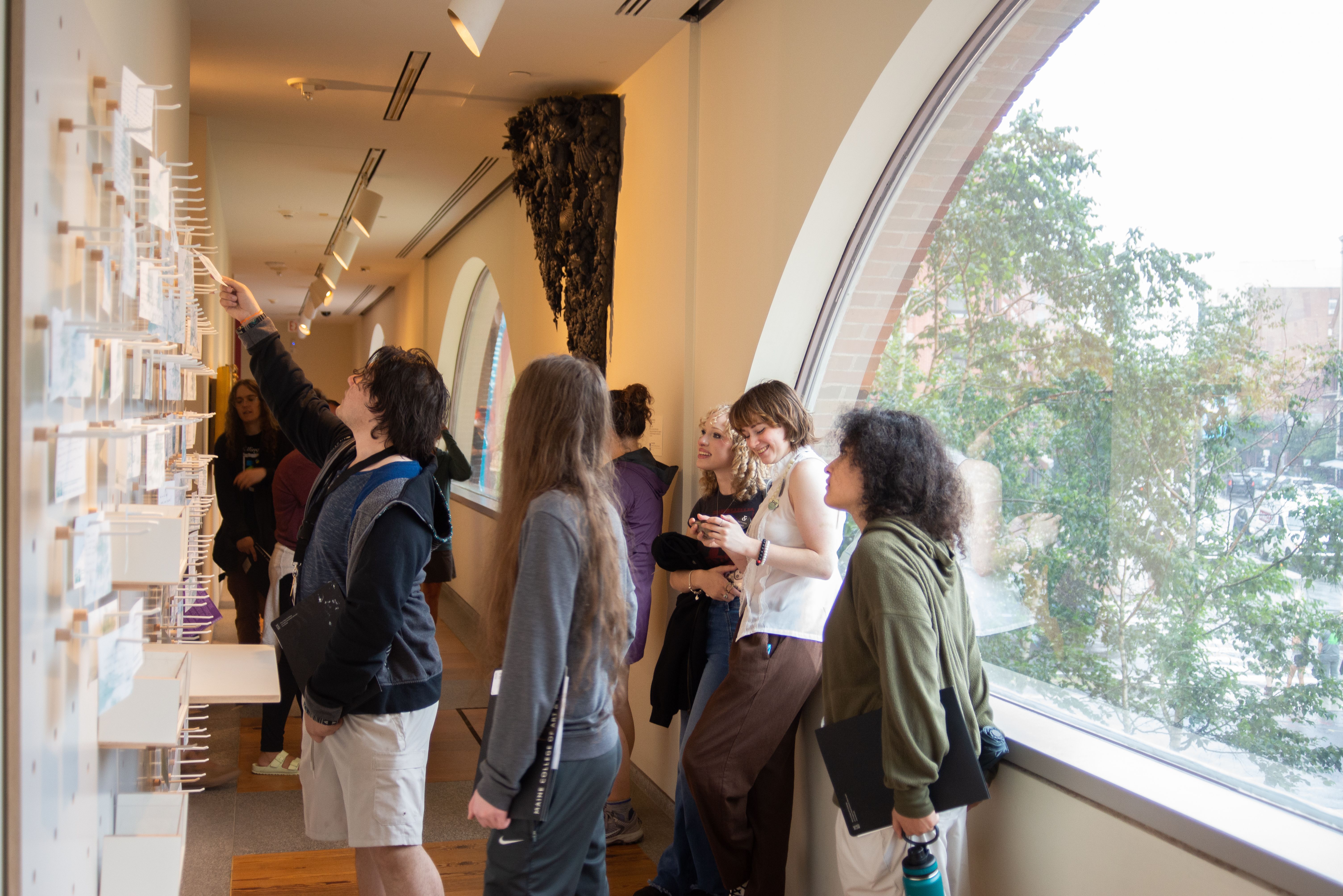 Students pointing at an installation at the Portland Museum of Art