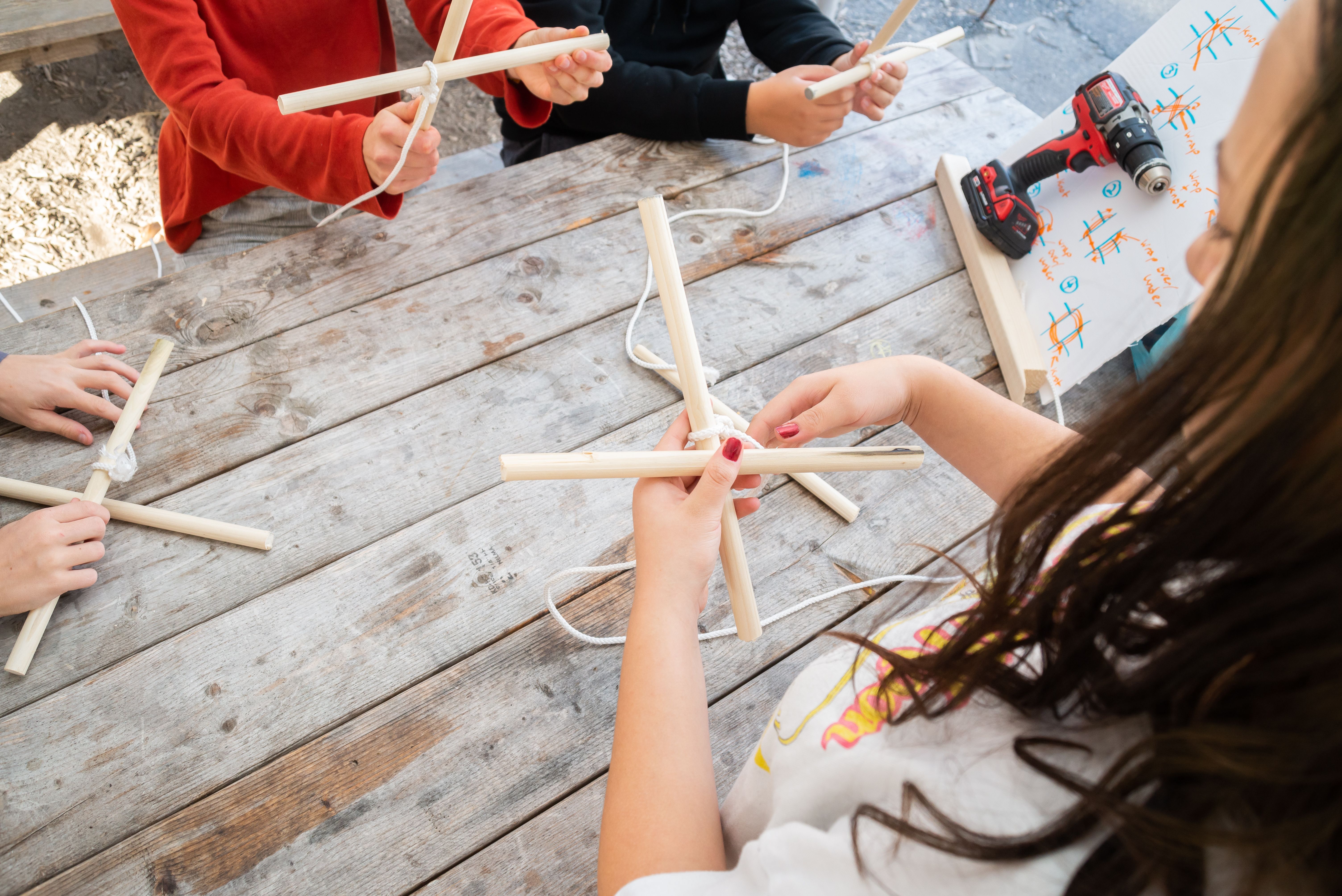 Demonstration of tying two sticks together.