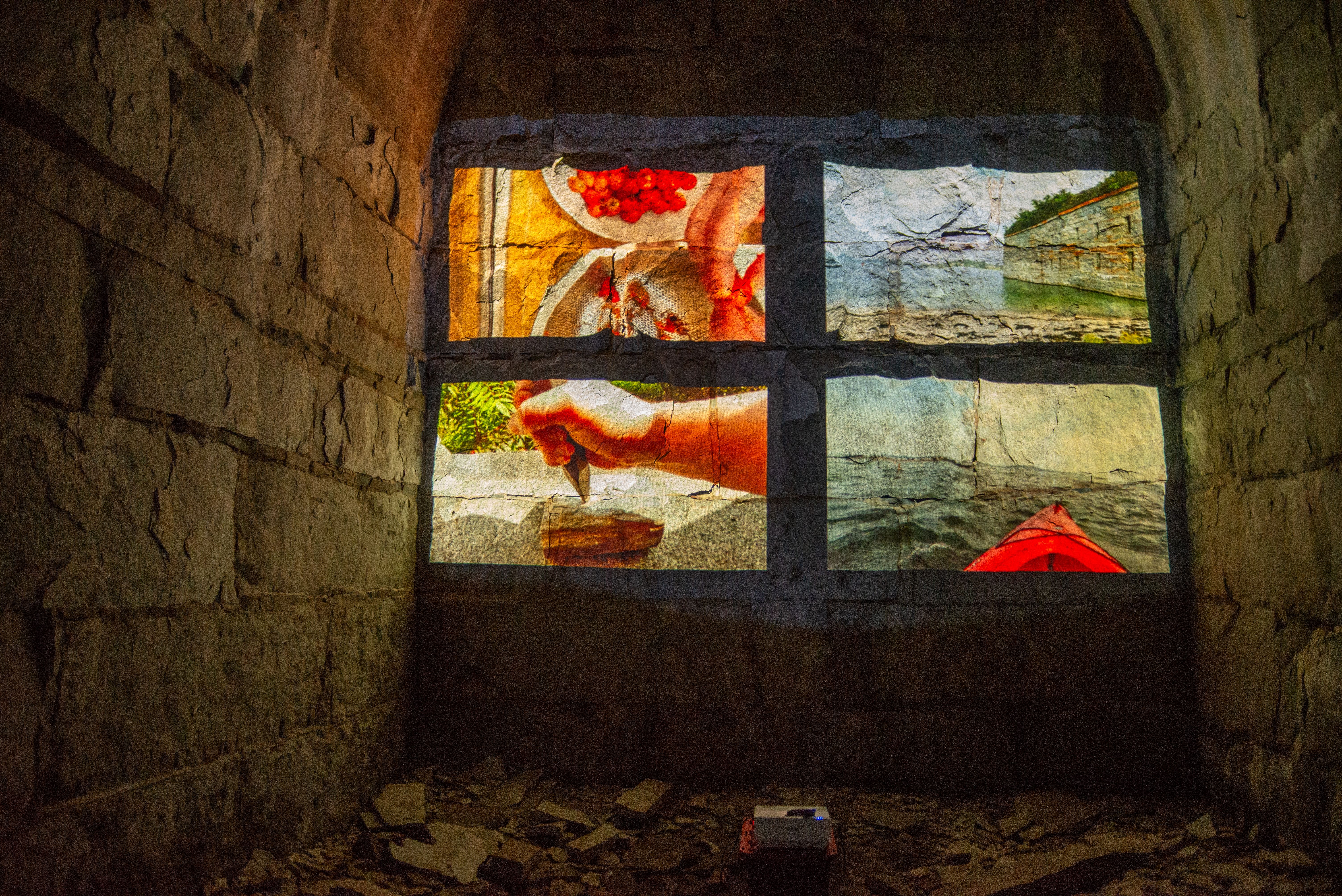 A four panel video projected on a wall inside Fort Gorges.