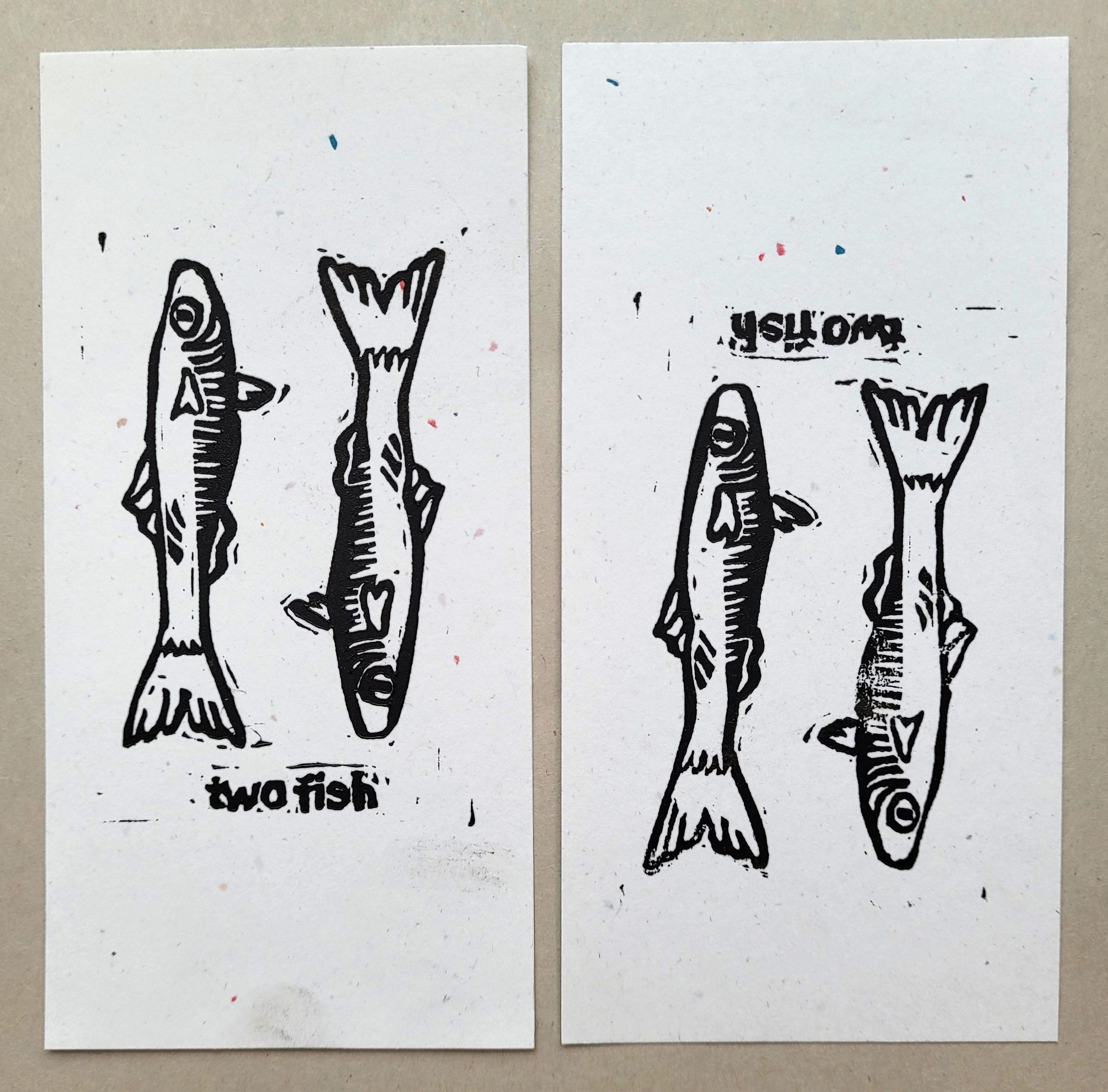 A print of two fist with the words, "two fish."