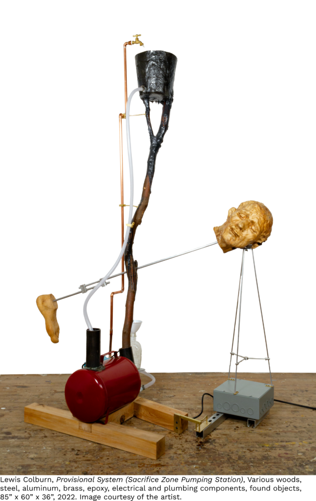 A kinetic sculpture where a head and a foot are connected by a pole.