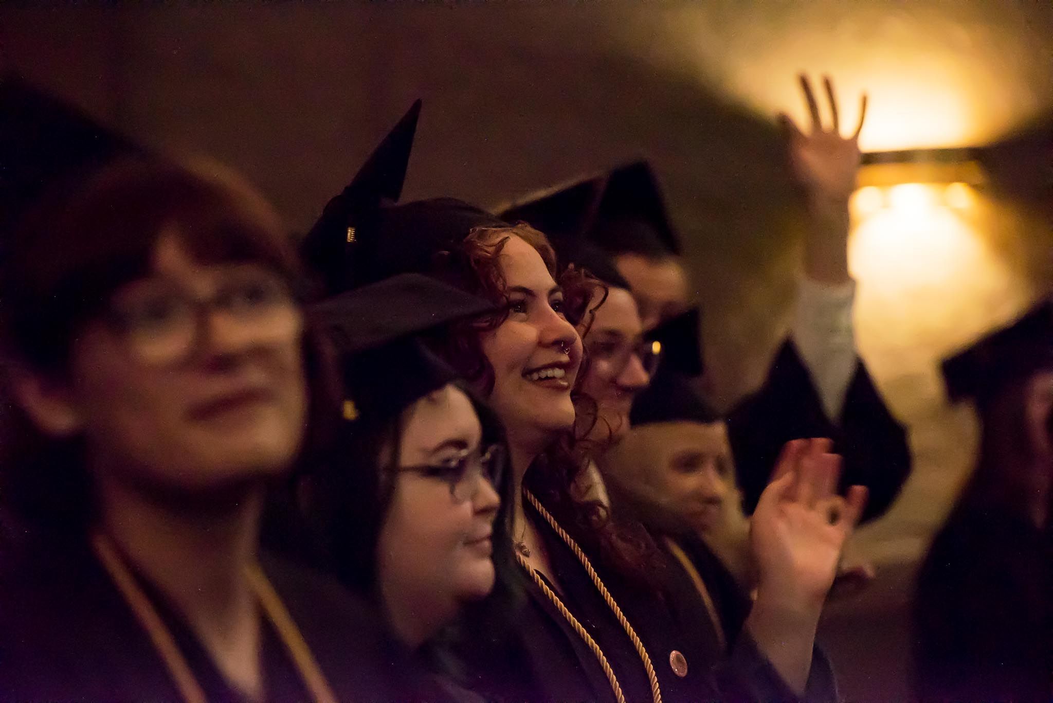 Graduating students cheering.