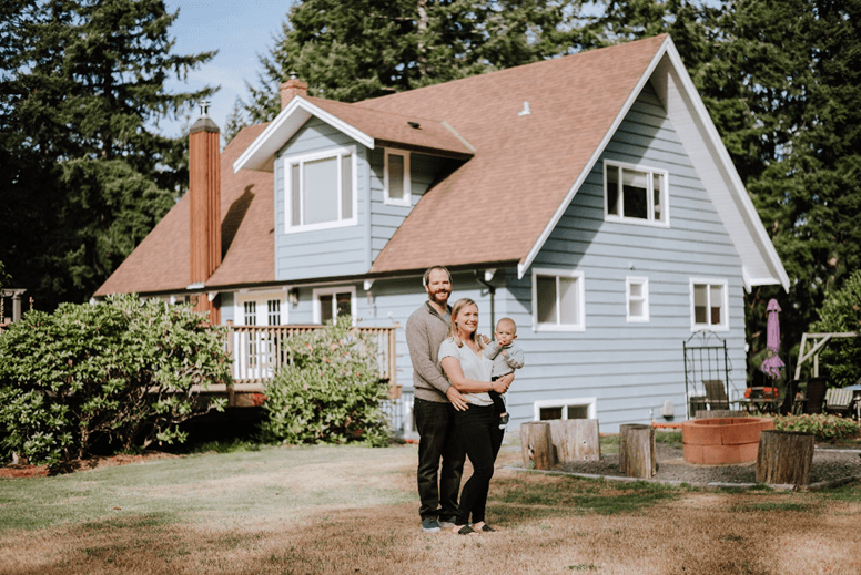Jason and his family in from of their home