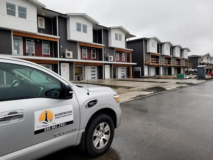 Lighthouse Energy Management business vehicle in front of laned homes
