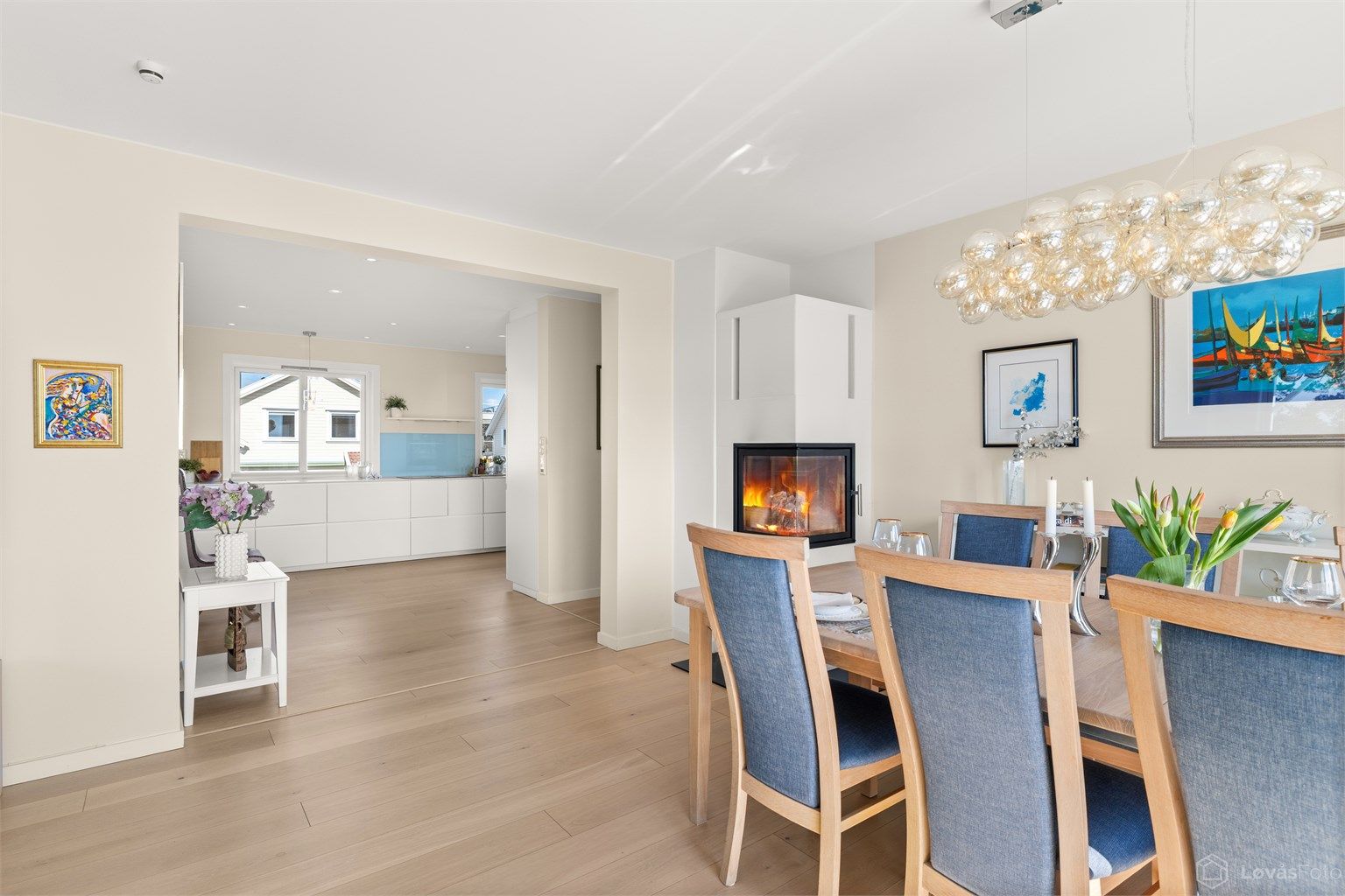 Den åpne passasjen mot kjøkkenet binder oppholdssonene elegant sammen.