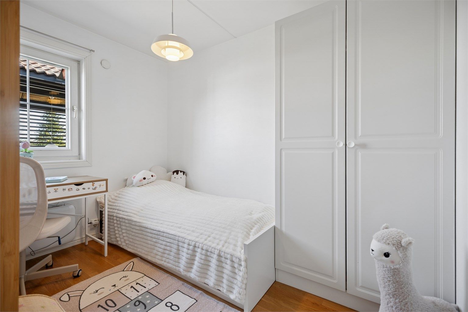 Soverom nummer to fremstår også lyst og delikat, og er praktisk innredet med garderobeskap som gir gode oppbevaringsmuligheter. 