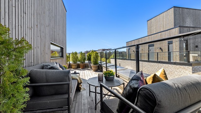 Terrassen er pent anlagt med tredekke og rekkverk i glass for å maksimere utsikten.