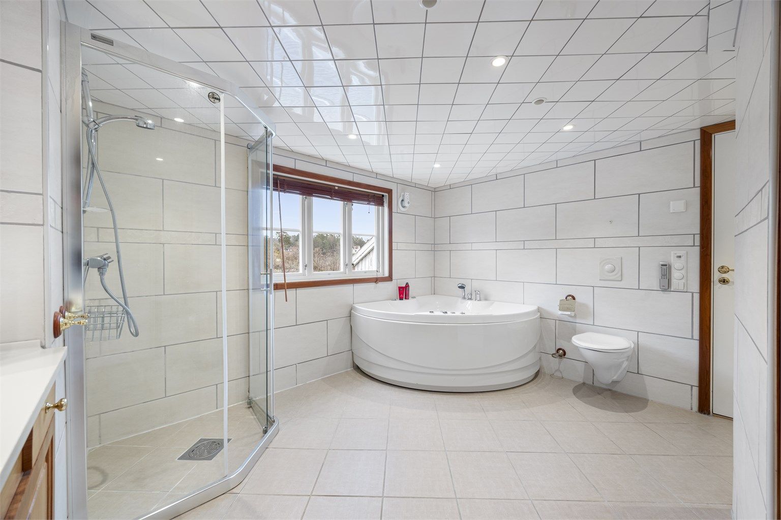 Stort bad med boblebad, varmekabler, stor dusj, servant, vegghengt toalett med mer.