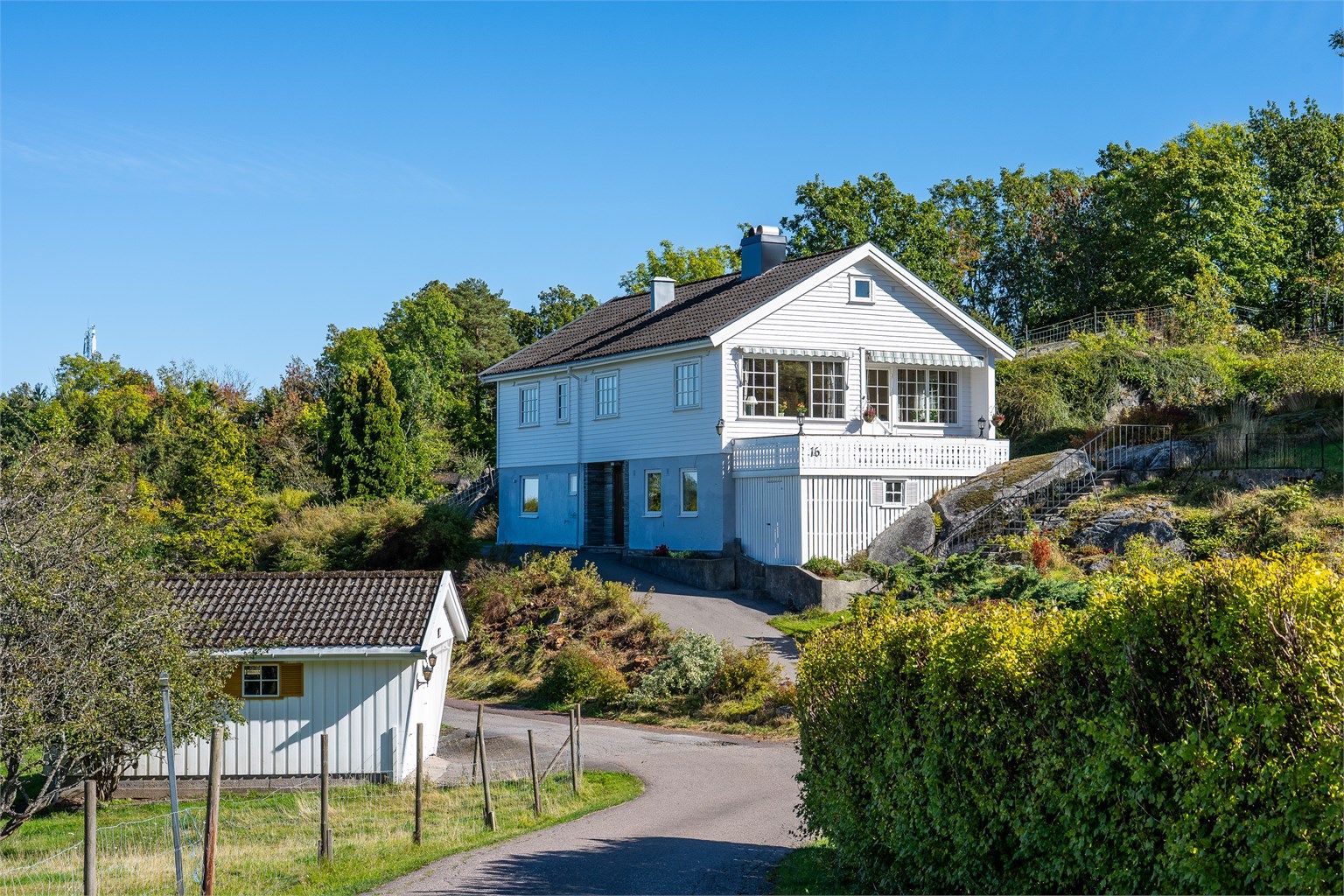 Eiendommen ligger i et rolig og etablert boområde omgitt av frodig vegetasjon.