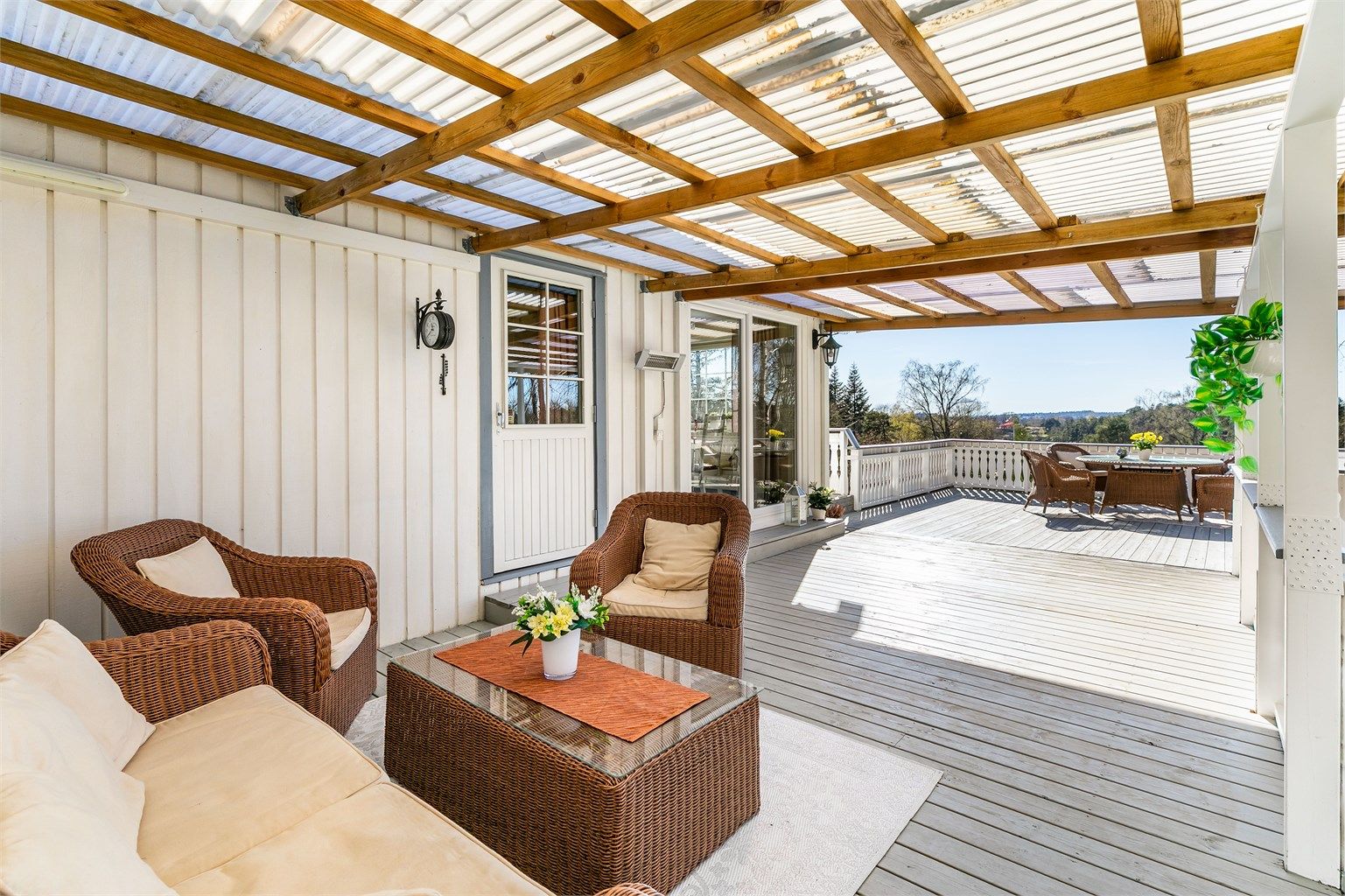 Med kjøkkenet rett innenfor kan måltidene enkelt å tas med utendørs. Skjermende overbygg gjør det mulig å sitte ute selv om sommerværet ikke er på sitt aller beste.