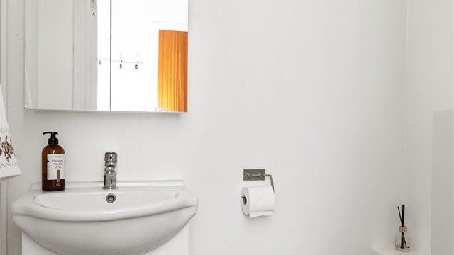 Separat toalettrom med gulvfliser slik som badet