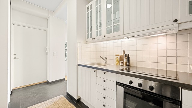 Kjøkkeninnredning fra 2007 med profilerte fronter, benkeplate med laminert overflate og nedfelt kjøkkenvask med armatur.
