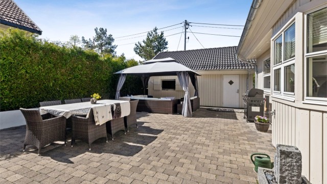 Fra kjøkkenet og stuen er det direkte utgang til en stor hellelagt terrasse