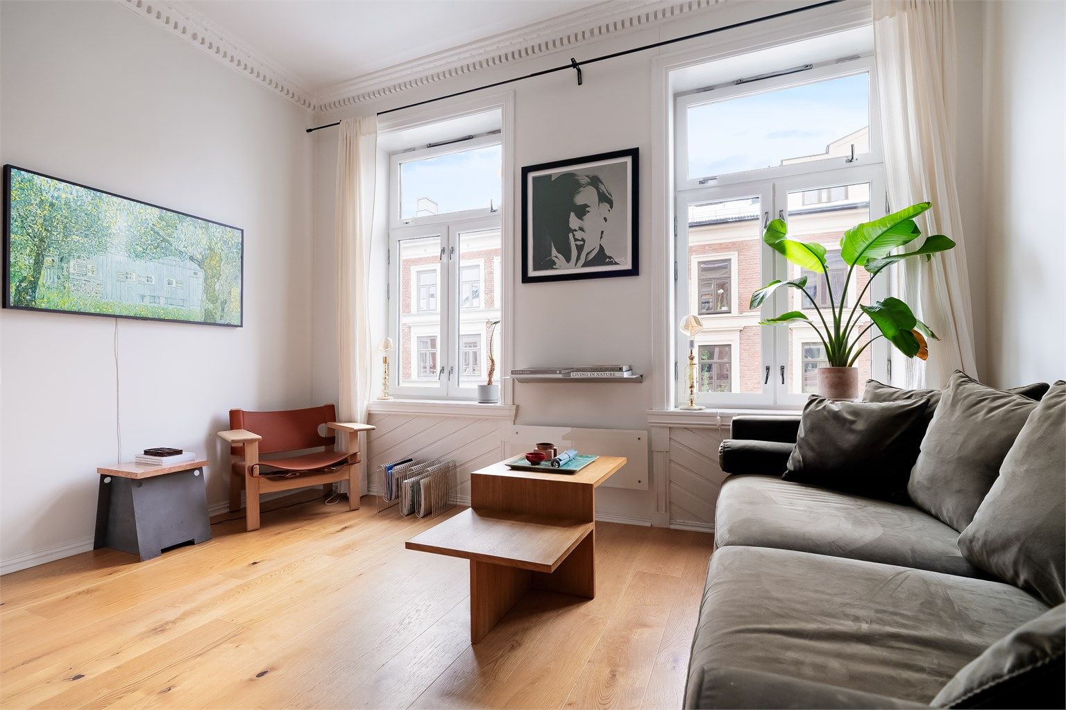 Stuen er romslig og har en takhøyde på hele 2,76 meter, noe som sammen med store vindusflater skaper en luftig og behagelig atmosfære med rikelig naturlig lys.