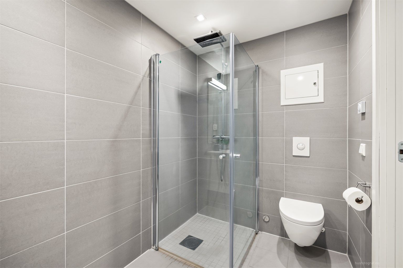 Badet har dusjhjørne med regnfallsdusj, downlights i tak og gulvvarme