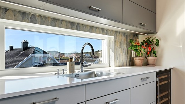 Det brede vinduet over kjøkkenbenken gir godt med arbeidslys og utsyn.