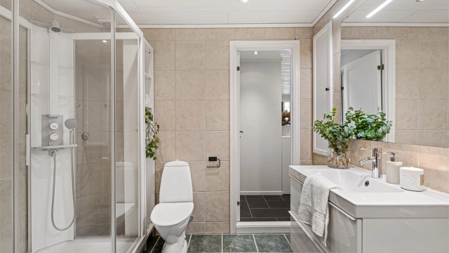 Det er badekar, dujskabinett, servant med skuffer og toalett. God størrelse.