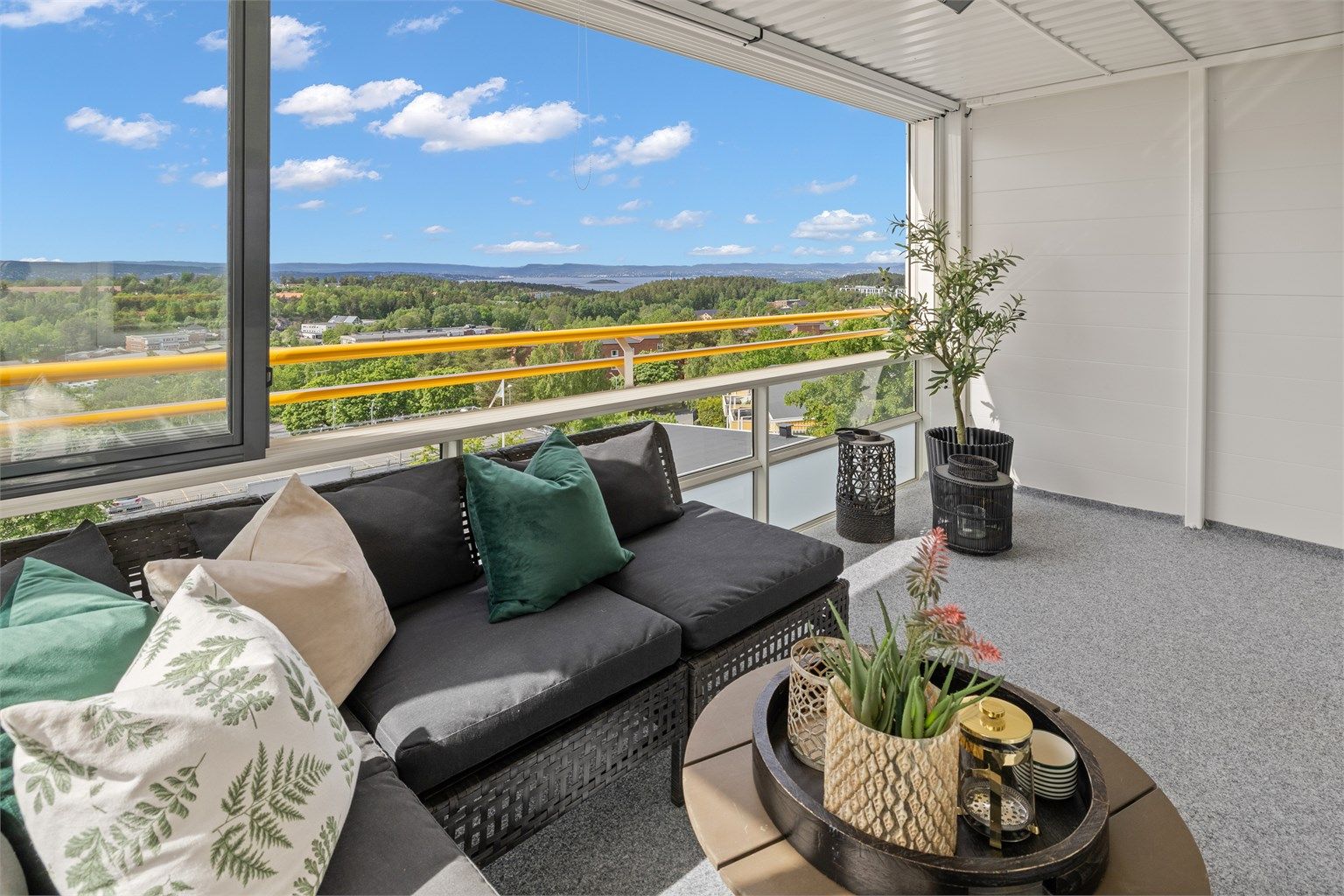 Fra stuen er det utgang til innglasset balkong på 10 kvm - et perfekt sted å nyte utsikten i lune omgivelser, uansett årstid.