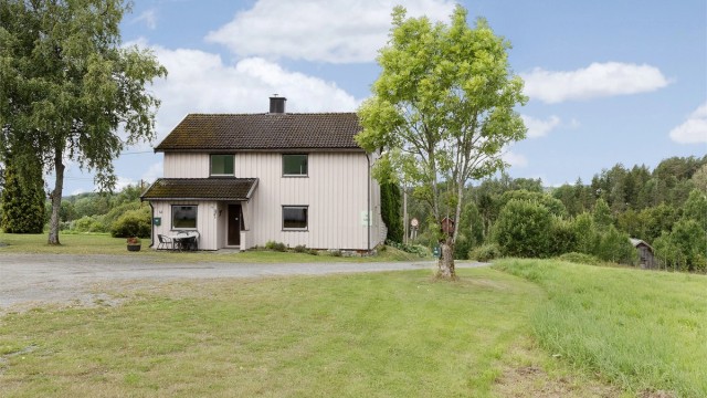 Gårdstunet er opparbeidet med grus og gressplen.