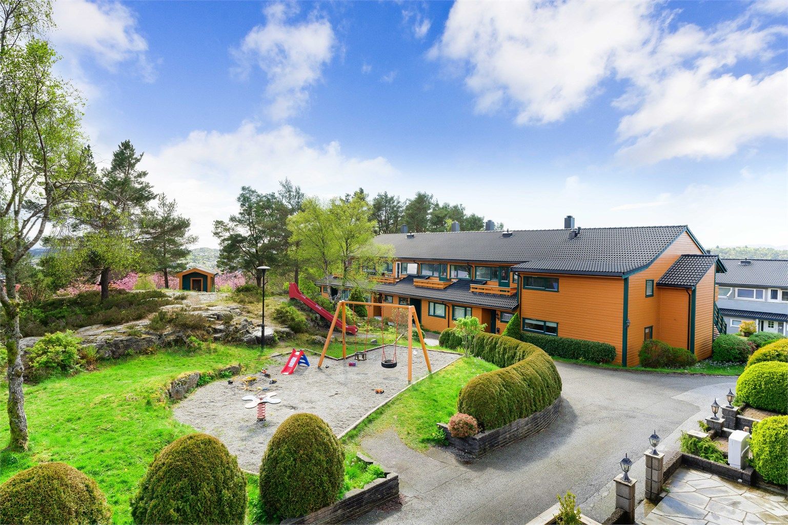 Det er lekeplass like utenfor boligen og man kan fint følge med de små i lek fra to av husets tre uteområder.