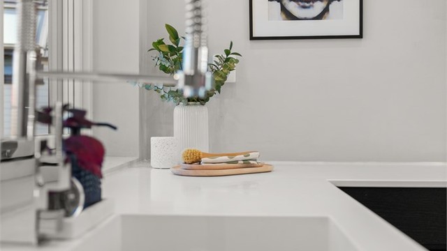Kjøkkeninnredningen har en helstøpt benkeplate og oppvaskkum i Corian.