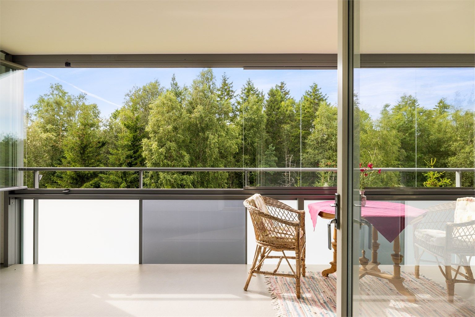 Ute som inne sees utsyn til grønne og fredelige omgivelser i skogholtet i vest.