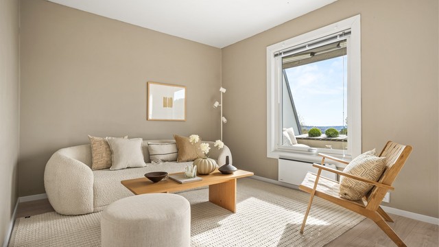 De malte overflatene og laminatgulvet gir et helhetlig og lyst inntrykk.