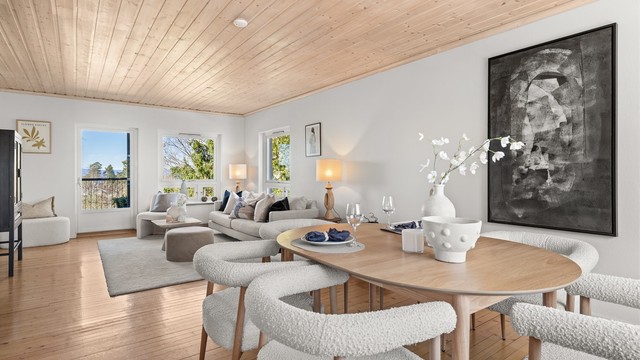 Lys og romslig stue/spisestue med originale tregulv