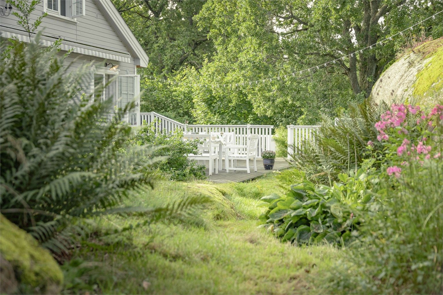 Eiertomten er på ca. 2,1 mål og består av det typiske og vakre Tjømelandskapet med svaberg opp i dagen, hvor huset er integrert i terrenget og tomten omkranset av store vakre eiketrær.  Foto: Kristian Bollæren v/Fotofinish