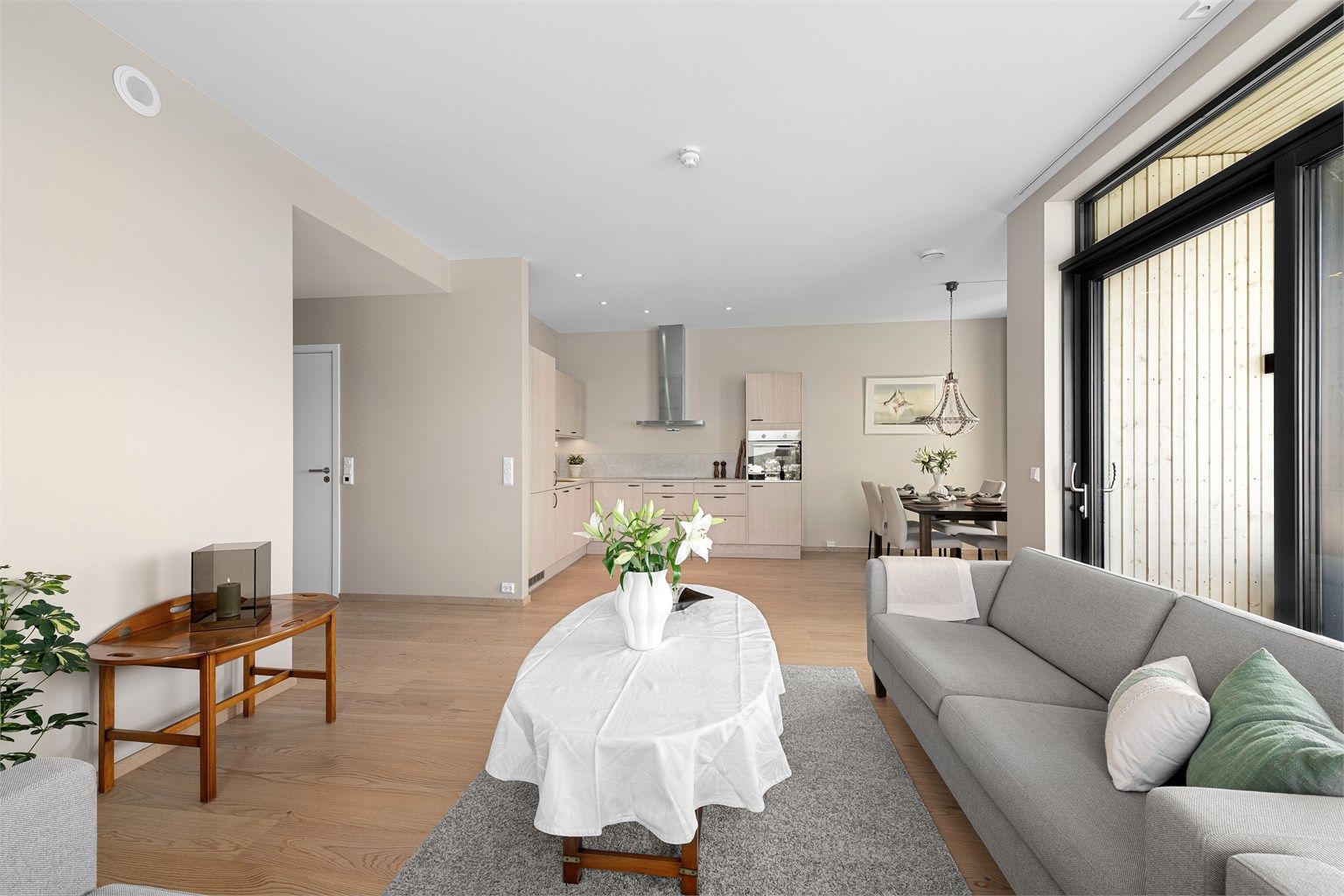 Gjennomgående parkett og lyse, malte flater skaper en helhetlig og luftig atmosfære