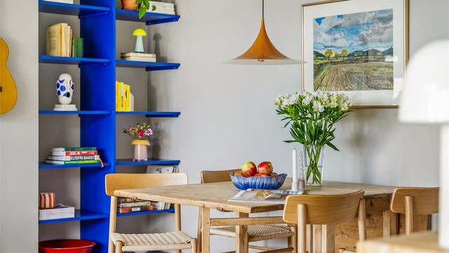 Plassbygget bokhylle malt i fargen Yves Klein blue er smykket i rommet