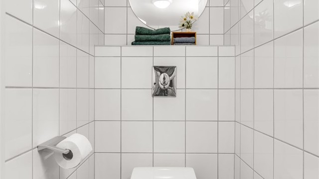 Videre er det vegghengt toalett. Badet ble i 2021 oppgradert med nytt servantskap, servant og armatur.