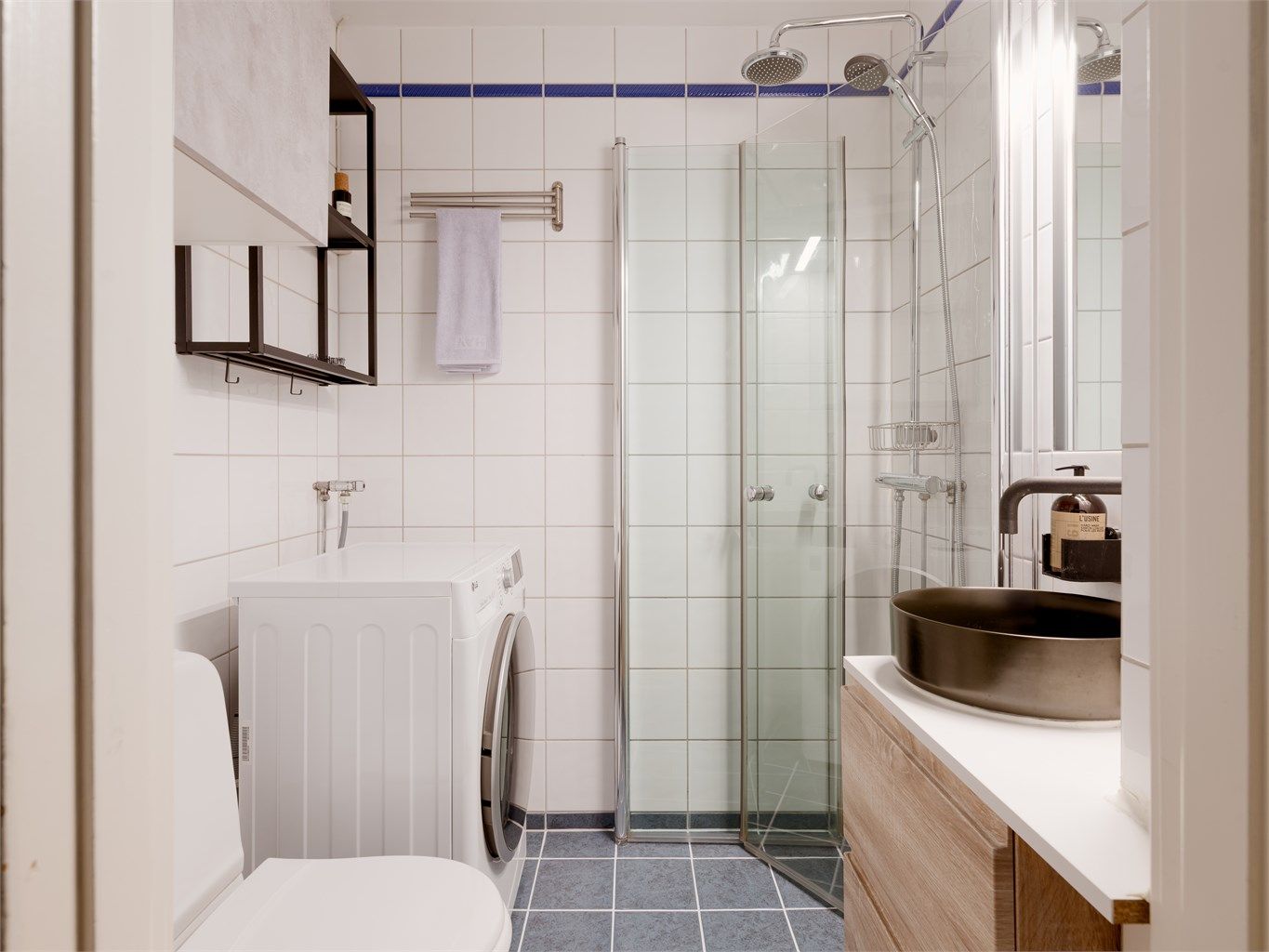 Lyst og pent flislagt bad med varme i gulvet som sørger for god komfort og en behagelig start på dagen. Baderomsinnredningen består av vegghengt servantinnredning med overpåliggende servant.