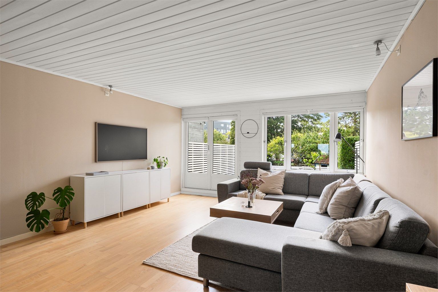 Boligen er påbygd både i stuen og i entréen. Stuen er svært romslig med plass til flere sittegrupper i tillegg til spisebord. (Foto: PBfoto Per Bendiksen)