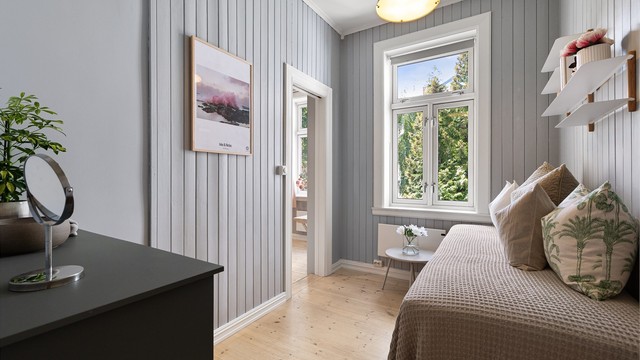 Soverom 2 har malt panel på veggene og har også direkte adkomst til badet.