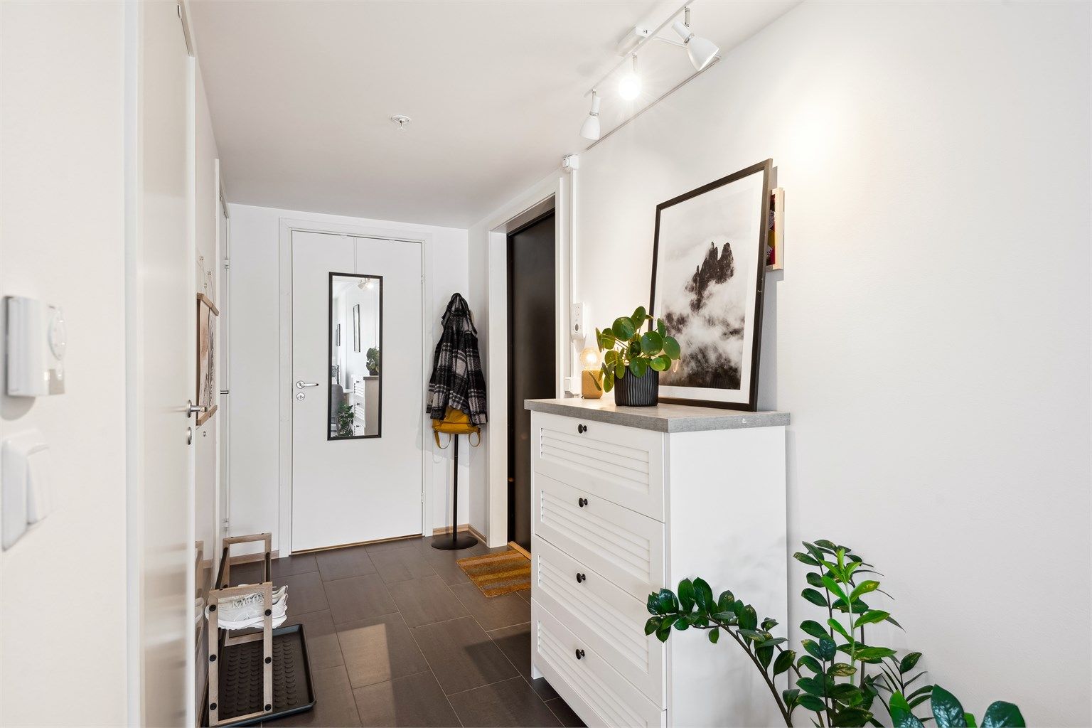 Lys entré med flislagte gulv med varme som byr på en lun og god velkomst