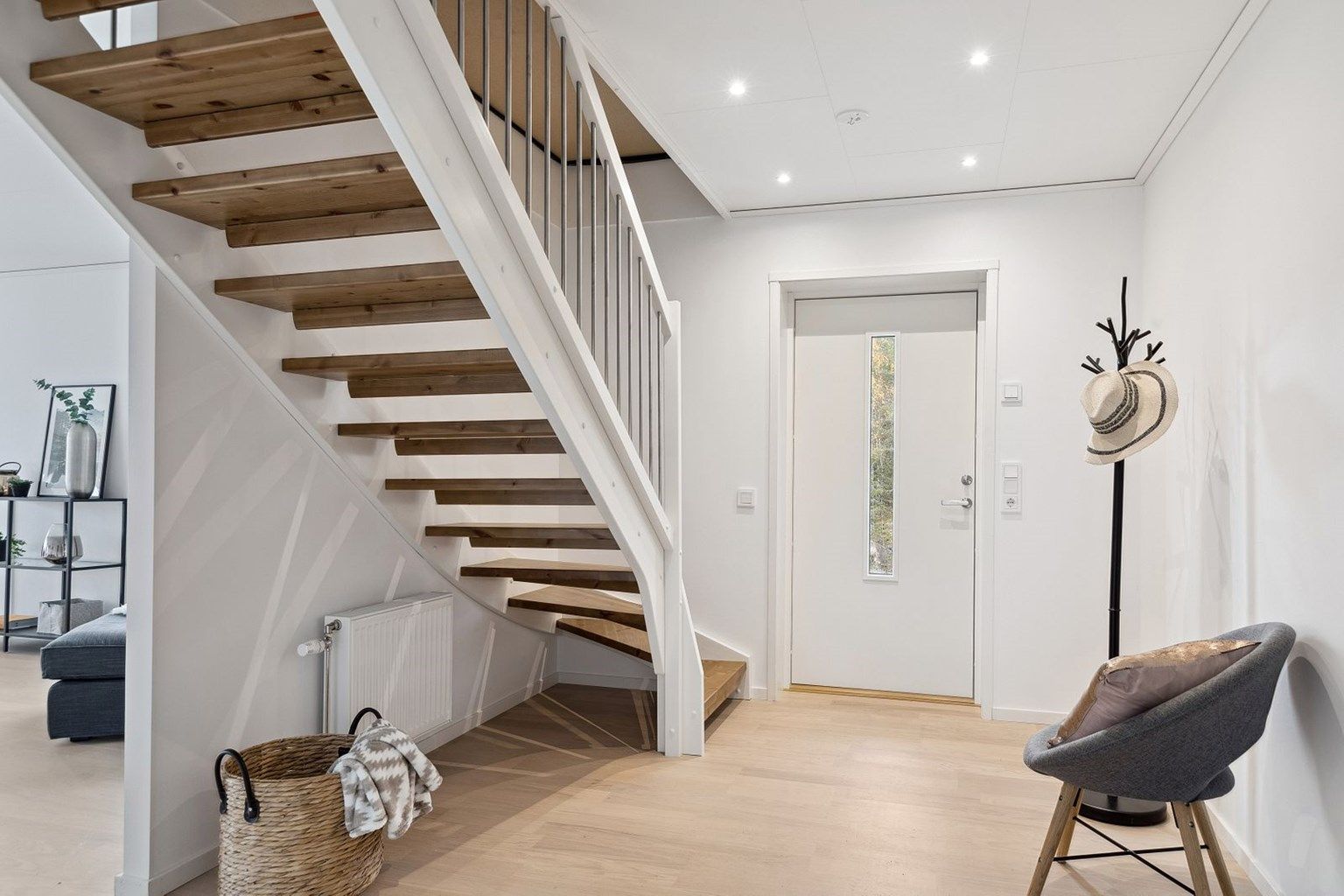 Entreen gir et godt førsteinntrykk til resten av boligen. Den praktiske planløsningen gir lett adkomst til vaskerommet og badet fra entreen, samt til stuen og via trappeløpet opp til uinnredet loftetasje. 